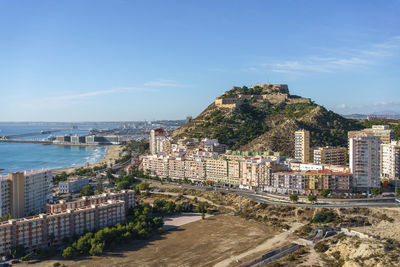 Alicante, spain. view of alicante harbour and santa barbara castle from serra grosa on a sunny day.