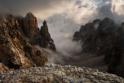 Scenic view of rocky mountains against cloudy sky