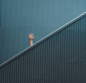 Low angle view of person hand on staircase