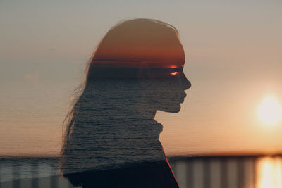 Portrait of woman by sea against sky during sunset