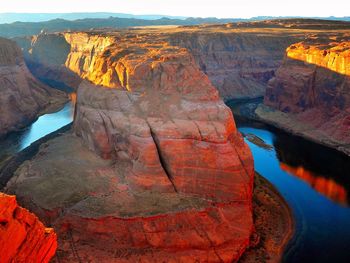 Scenic view of horseshoe bend by river against sky