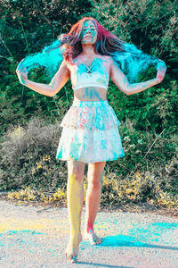 Full length of a young woman standing outdoors