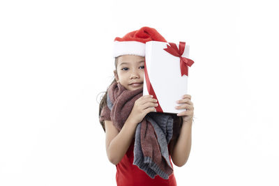 Portrait of woman holding red umbrella against white background