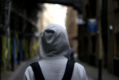 Rear view of man in hood outdoors