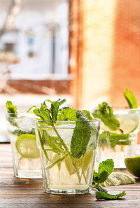 Close-up of drinks served on wooden table