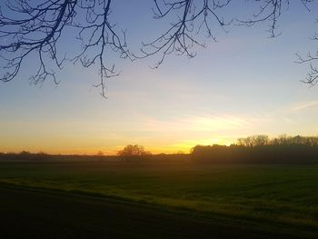 Scenic view of field against sky during sunset