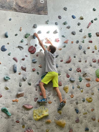 A boy climbing on the wall