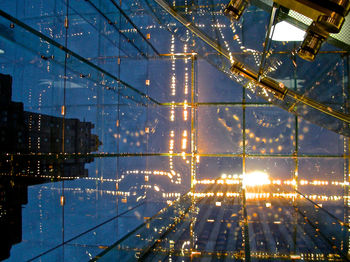 Illuminated cityscape against sky at night