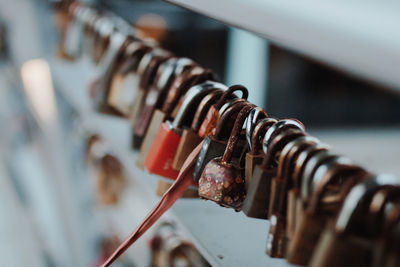 Close-up of padlocks hanging on railing