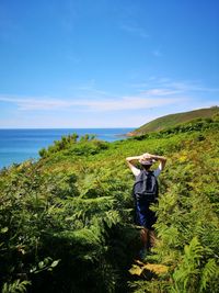 Man photographing sea against sky