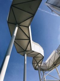 Low angle view of bridge against blue sky during sunny day