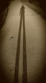 Shadow of man on road