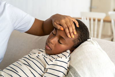 Midsection of doctor examining patient at home