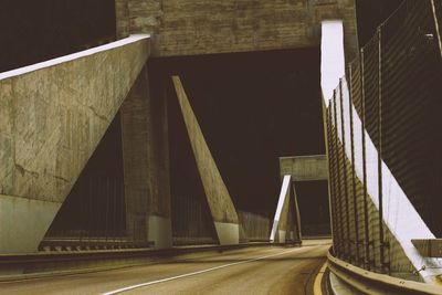 Empty illuminated bridge at night