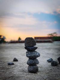 Stack of stones on beach during sunset