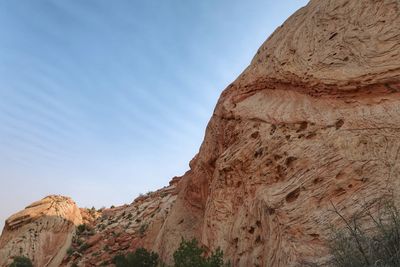 Low angle view of rock formations against sky