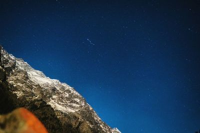 Low angle view of stars against blue sky