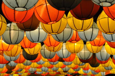 Low angle view of illuminated lanterns hanging in row