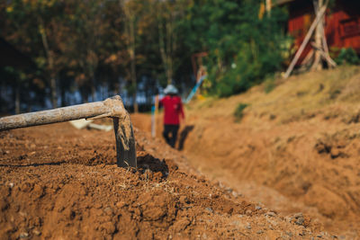 Tool against man walking on land