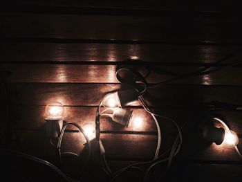 Close-up of illuminated lighting equipment on table