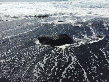 High angle view of rock on shore at beach