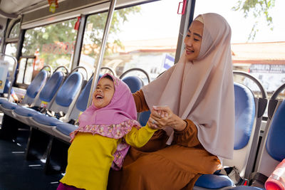 Portrait of woman sitting in bus