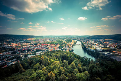 High angle view of townscape by river against sky