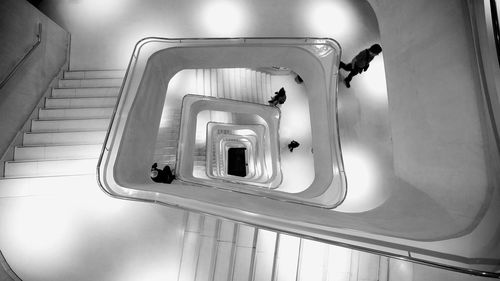 High angle view of people walking on steps in building
