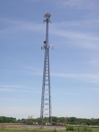 Low angle view of communications tower against sky