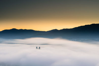 Scenic view of silhouette mountains against sky during sunset