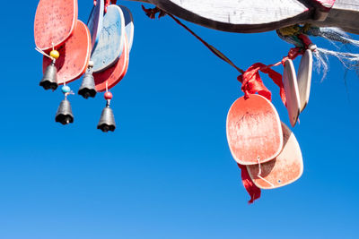 Low angle view of umbrellas hanging against sky