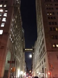 Low angle view of illuminated city street at night