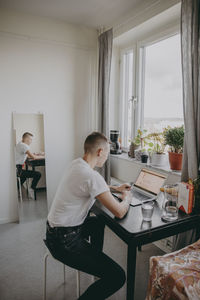 Man sitting on table at home