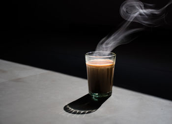 Close-up of coffee on table against black background