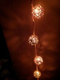 Low angle view of illuminated chandelier hanging from ceiling