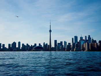 Lake ontario with buildings in background against sky