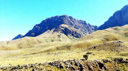Scenic view of mountains against clear blue sky