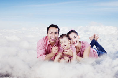 Rear view of father and daughter against sky