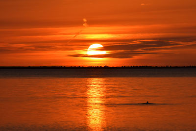 Scenic view of sea against orange sky