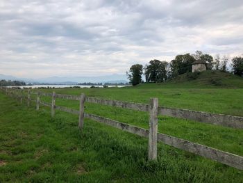 Fence on field against sky