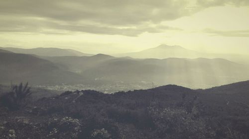 Scenic view of mountains against cloudy sky