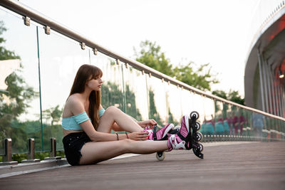 Side view of young woman exercising in gym