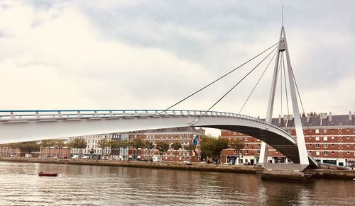 Bridge over river with buildings in background
