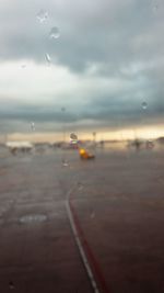 Close-up of wet car window during rainy season