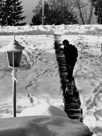 Rear view of people on snow covered street