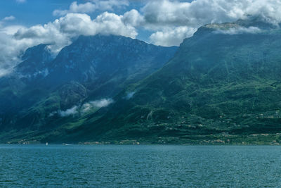 Scenic view of sea and mountains against sky