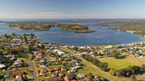 High angle view of townscape by sea against sky
