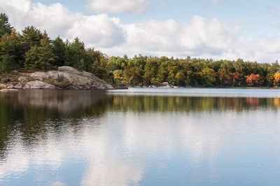 Scenic view of calm lake against trees