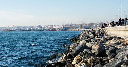 Scenic view of sea by buildings against sky