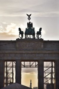 Low angle view of statue against cloudy sky